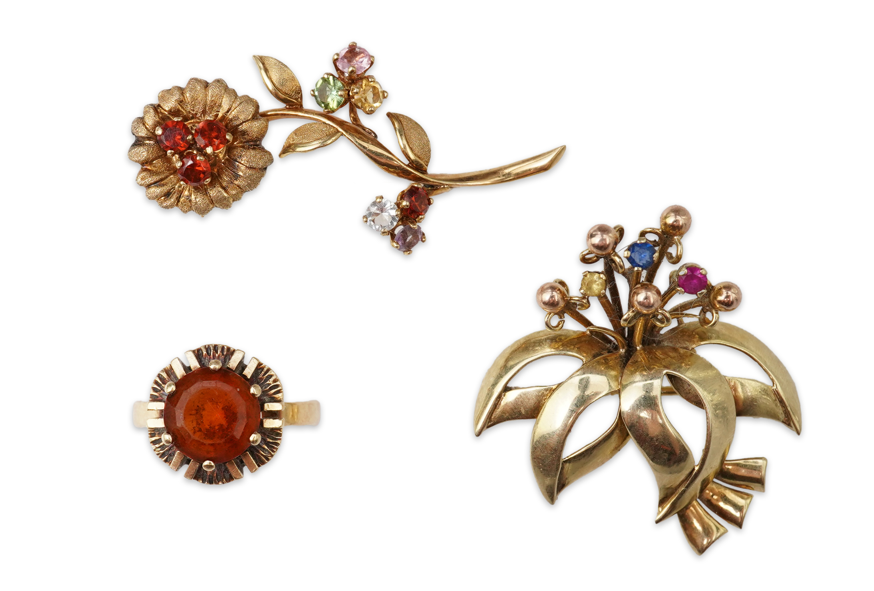 Two brooches and a ring, mid 20th century, comprising: a brooch of floral design, set with circular-cut synthetic gemstones, length 3.7cm, Austrian assay marks for gold, gross weight approximately 6.5 grams; a brooch des